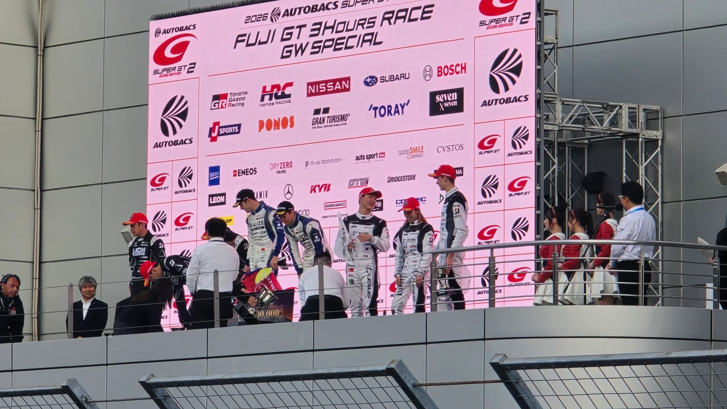 The drivers from the No. 56, No. 65, and No. 31 teams celebrate on the GT300 podium at Fuji Speedway.