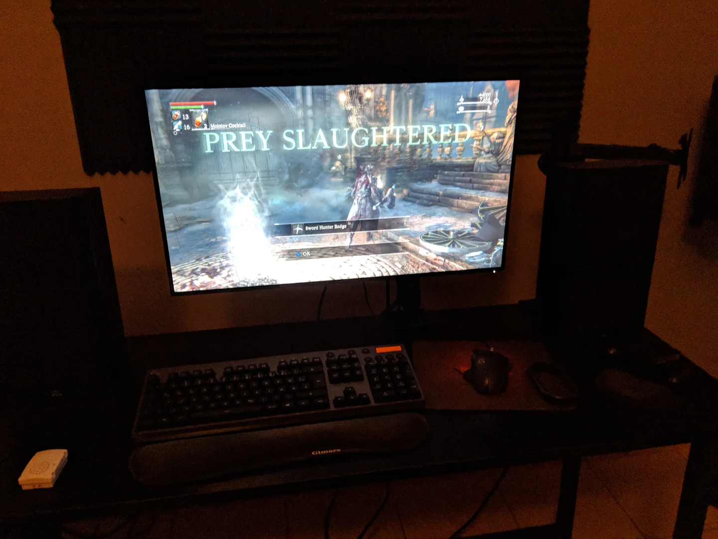 A television shows the Prey Slaughtered victory message in Bloodborne.